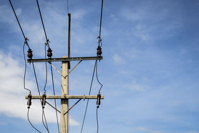 Top part of low voltage electric pole in sunny day