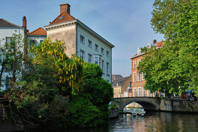 Bridge over river amidst buildings in city