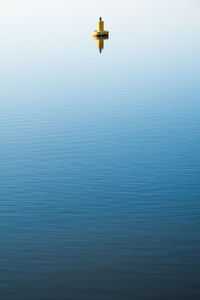 Yellow buoy on still water 