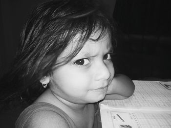 Close-up portrait of cute girl studying at home