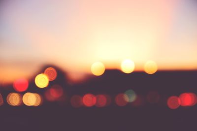 Defocused image of lights against sky at night