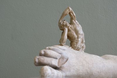 Close-up of statue against white wall