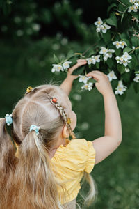 Summer activities and connecting with nature for kids. cute little girl with two ponytails runs