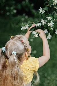 Side view of woman with flowers