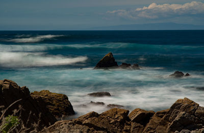 Scenic view of sea against cloudy sky