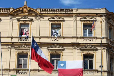 Low angle view of flags hanging on building
