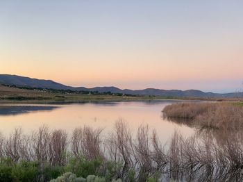 Scenic view of lake against sky during sunset