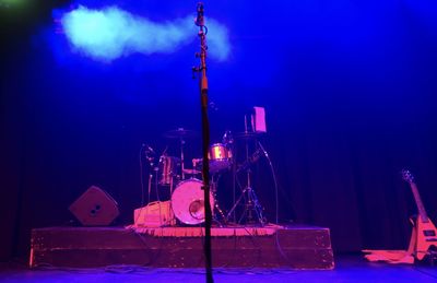 Illuminated lighting equipment against blue sky at night