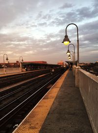 Illuminated railroad station platform at dusk