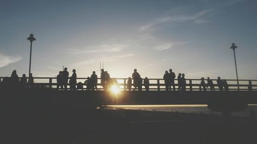 Silhouette of people at sunset