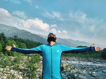 Full length of man standing on mountain against sky