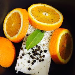 Close-up of orange slices with spices on table