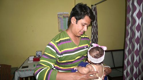 Man playing with daughter at home
