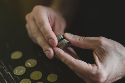 Business man counting money. rich male hands holds and count coins of different euros on table