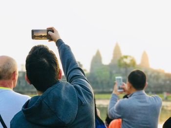 Rear view of people photographing from mobile phones
