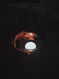 High angle view of illuminated lamp in darkroom