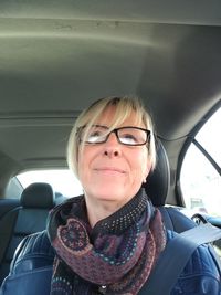 Portrait of smiling woman in car