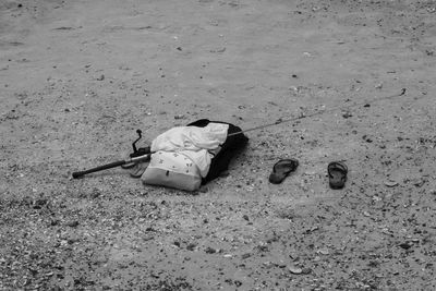 High angle view of abandoned shoes on sand