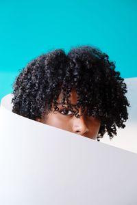 Portrait of a beautiful black woman with curly hair on a geometric background