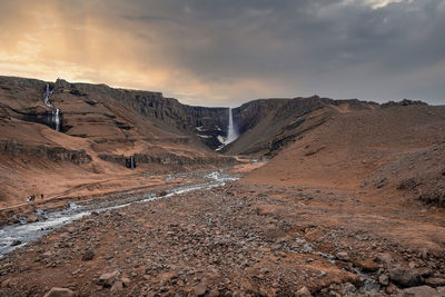 Scenic view of litlanesfoss and hengifoss waterfall at eastfjords during sunset