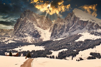 Scenic view of snow covered mountains against sky