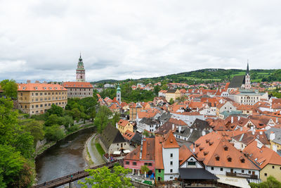 High angle view of townscape and river against sky