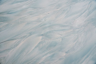 Natural sand texture with wave mark on wet beach for eco-friendly projects