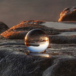 Close-up of crystal ball on rock