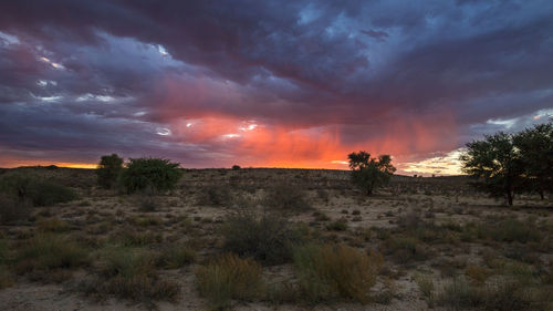 Scenic view of land against sky during sunset