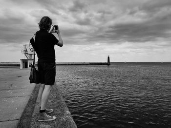 Rear view of woman standing on beach