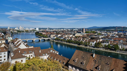 High angle view of city by river against sky