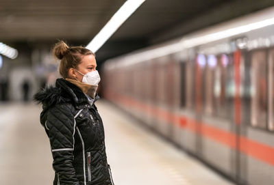 Full length of woman standing at railroad station