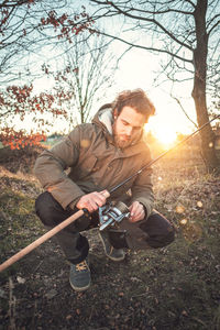 Young man photographing camera on land