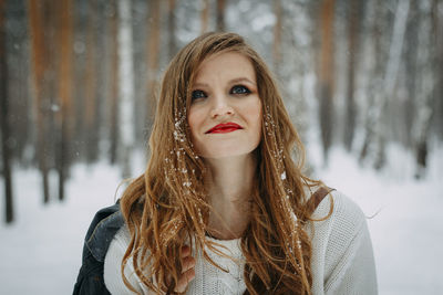 Portrait of young woman in snow