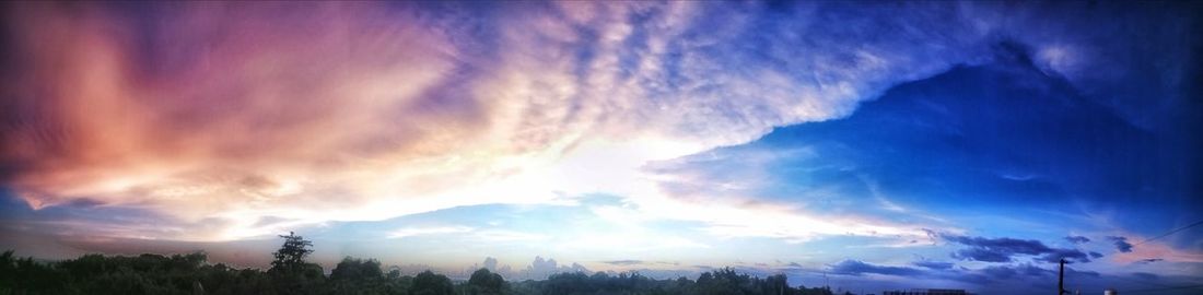 Panoramic view of mountains against blue sky