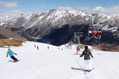 People skiing on snowcapped mountain