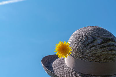 Low angle view of hat against clear blue sky