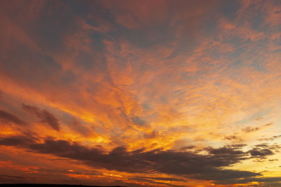 Low angle view of dramatic sky during sunset