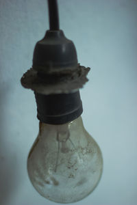 Close-up of water bottle on glass against white background