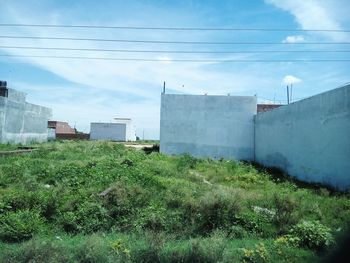 Built structure on field against blue sky