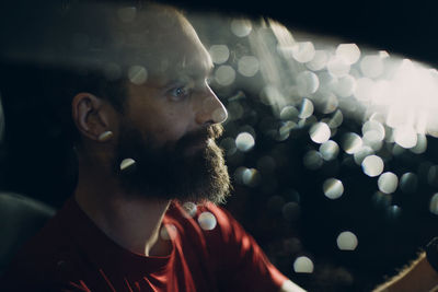 Man sitting in car during rainy season