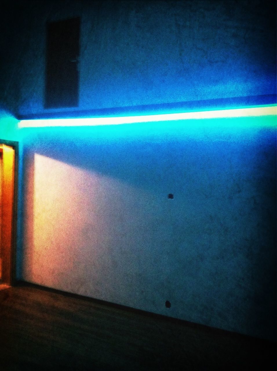 illuminated, indoors, night, light - natural phenomenon, lighting equipment, blue, dark, multi colored, wall - building feature, pattern, no people, window, built structure, empty, light, wall, flooring, abstract, glowing, absence