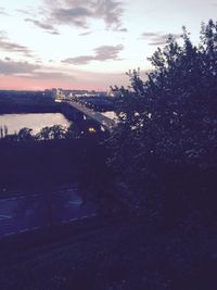 Bridge over river against sky in city