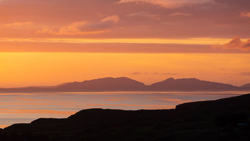 Scenic view of sea against romantic sky at sunset