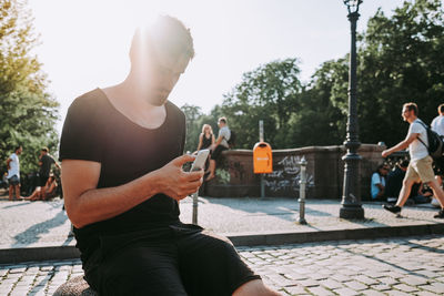 Man using mobile phone in park