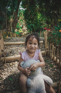 Portrait of smiling girl sitting outdoors