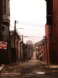 Street amidst buildings against sky in city