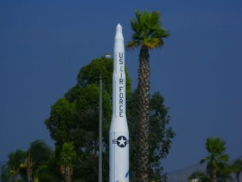 Low angle view of information sign against clear blue sky