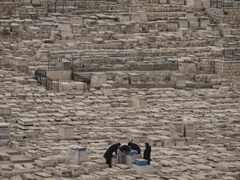 People praying amidst rocks