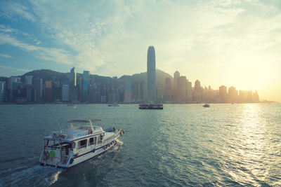 Scenic view of sea and buildings against sky during sunset